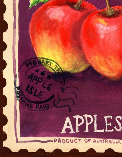 A close-up of a vintage-style apple illustration or print showing two red apples on a purple background with the word "APPLES" and "Product of Australia" visible, plus a stamp-like mark reading "Hobart 73 Apple Isle Page Paid.".