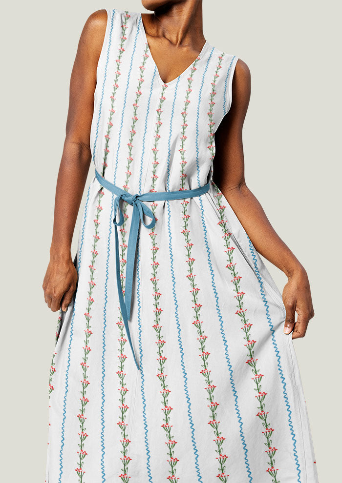 A delicate watercolour pattern printed on linen dress featuring little flowers and ribbon stripes artwork by Laura Hamzic Brisbane Surface Pattern Designer