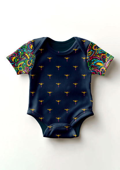 Rainbow Paisley Days pattern on navy, baby onesie sleeves with Sea Petal body. Pattern design by Laura Hamzic, Australian Artist.