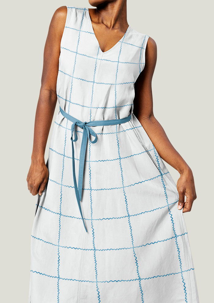 A delicate watercolour pattern printed on linen dress featuring ribbons in a check layout artwork by Laura Hamzic Brisbane Surface Pattern Designer
