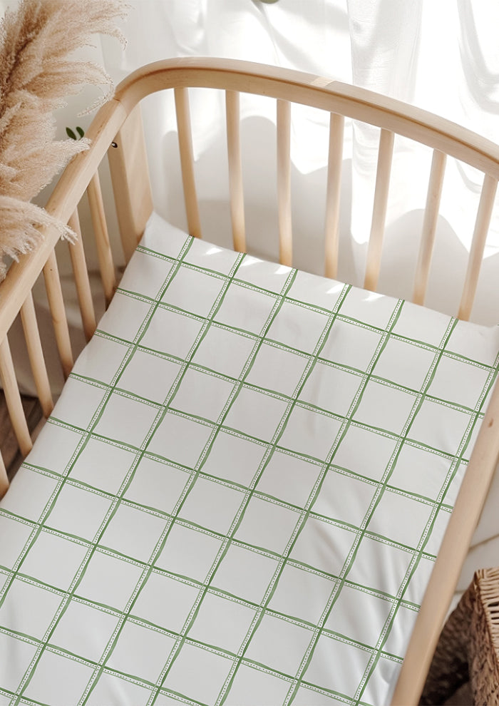 Gentle garden trellis inspired cot sheets featuring a watercolour check— baby bedding surface pattern design.