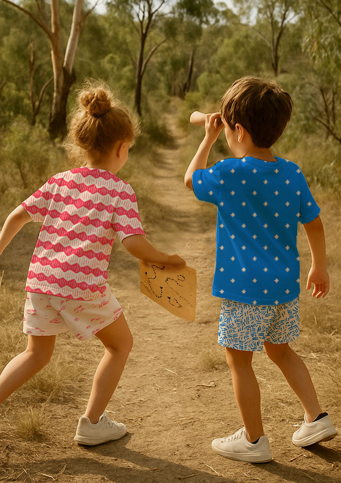 Children’s clothing featuring Zig Zag Track, Star Bright, Spinifex Scatter, Etched Earth patterns – bold coloured pencil surface design inspired by bushwalks and outback adventures, Australian kidswear fabric.
