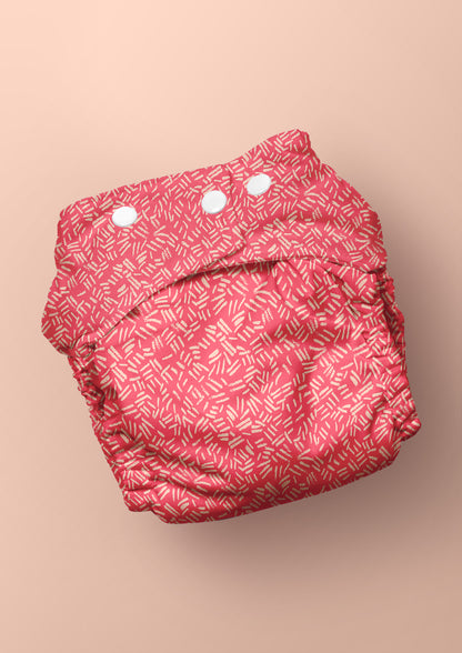Baby nappy with earthy textured surface pattern – pencil-drawn marks inspired by cracked ground and natural bush etchings. Unique, adventurous design for kidswear and baby textiles.