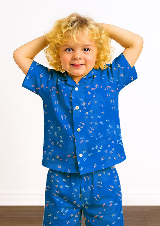 Blue kids pajamas featuring whimsical Australian wildlife footprints – kangaroo, echidna, wombat, and more – inspired by bushland trails and nature’s stories. Surface pattern design Australia.